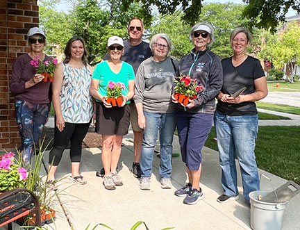 NNNC volunteers helping Bridge Communities plant flowers for Families Helping Families