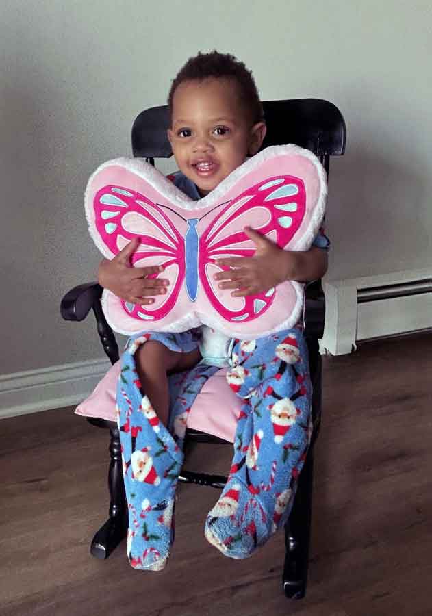 Boy hugging a butterfly pillow