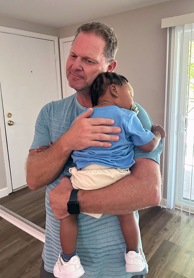 Mentor holding baby